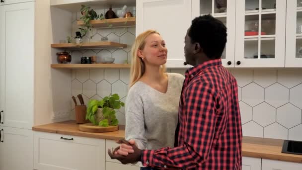 Multiethnic family couple in love listening to music slow dance at home kitchen — Stockvideo