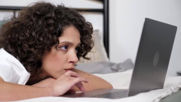 Close up hispanic curly woman student uses laptop search information on Internet — Video