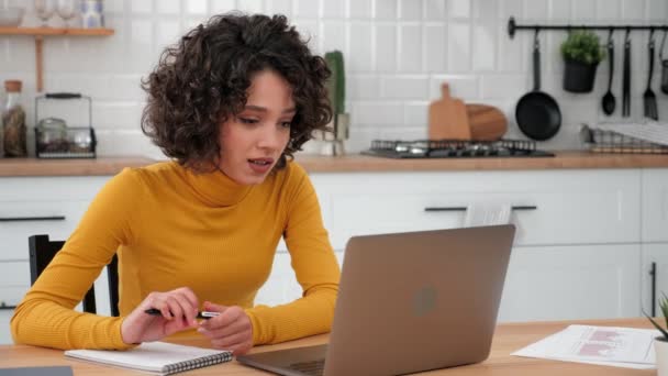 Smiling curly woman student greets studying talking online video call laptop — Stok video