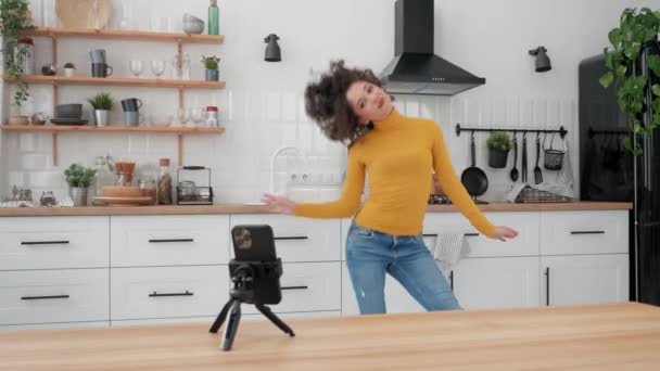 Woman blogger dancing on smartphone camera recording video for social media — стоковое видео