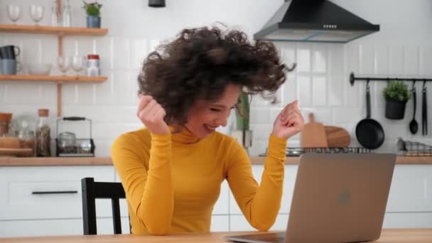 Excited curly woman student winner celebrating admission to university, laptop — Stockvideo