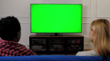 Yeşil ekran TV, çok ırklı çiftler televizyonun kroma tuşuna bakıp görüntüleme düzenini oluşturur
