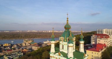 Aerial view Kyiv St. Andrews Church at beautiful sunset. Drone flies over old Kiev - podil. Andrews Descent