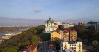 Aerial view Kyiv St. Andrews Church at beautiful sunset. Drone flies over old Kiev - podil. Andrews Descent