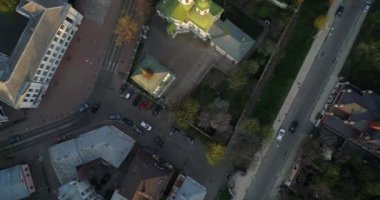 Aerial view streets of Kyiv on which cars drive at beautiful sunset or sunrise. Drone shot old Kiev - podil