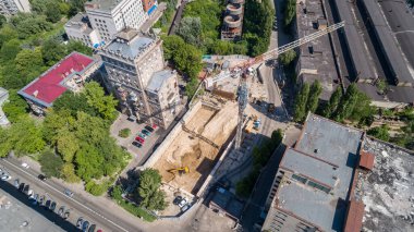 Drone aerial view to the land plot on which the construction process is taking place on a sunny summer day. Building former factory Arsenal. Kyiv Kiev capital of Ukraine
