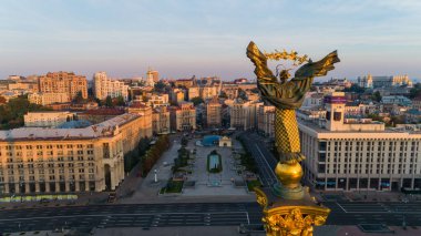 Independence Square. Ukraine. Kyiv. September 12, 2021. Aerial drone photo back view Independence Monument at sunrise or sunset on Maidan Nezalezhnosti. Golden beautiful Ukrainian woman statue