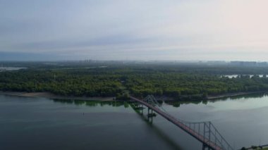 Drone aerial view Kyiv Truchaniv island, pedestrian bridge and Dnieper river on a beautiful sunny spring day. Capital of Ukraine