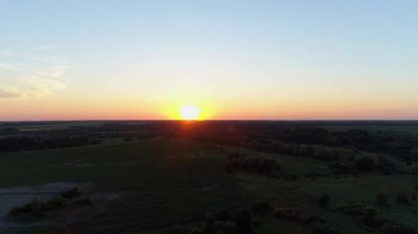 Hava manzaralı gün batımı ya da tarlada gün doğumu. İnsansız hava aracı güzel bir yaz akşamı ya da sabah güneşini ormanda çeker.