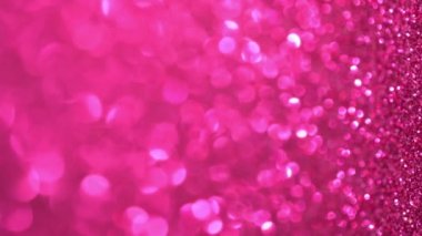 Pembe Parıldayan Arkaplan. Hafif bokeh, sihirli noel ışıkları. Sihirli toz, parlak doku, tatil ışıkları, uçan parçacıklar güzel bir bokeh oluşturur. Parlak Noel arkaplanı. Dikey Video