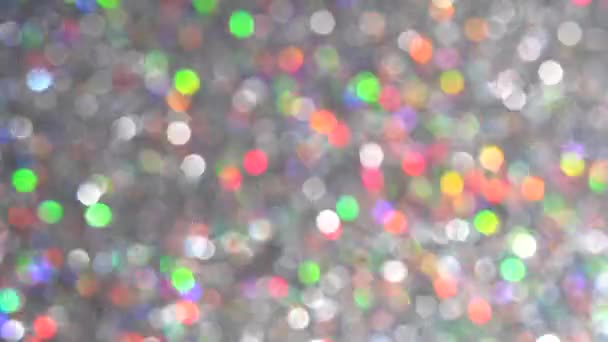 Magisk festlig silver bakgrund för gott nytt år. Neon pastell ljusa magiska ljus abstrakt bakgrund. Suddiga färgglada ljuspunkter. Damm eller flygande partiklar — Stockvideo