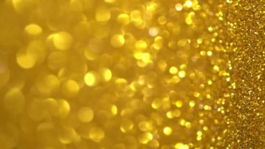 Altın Parıltı Arkaplanı. Hafif bokeh, sihirli noel ışıkları, parlak dokular, tatil ışıkları, uçan parçacıklar güzel bir bokeh oluşturur. Parlak Noel arkaplanı. Dikey Video