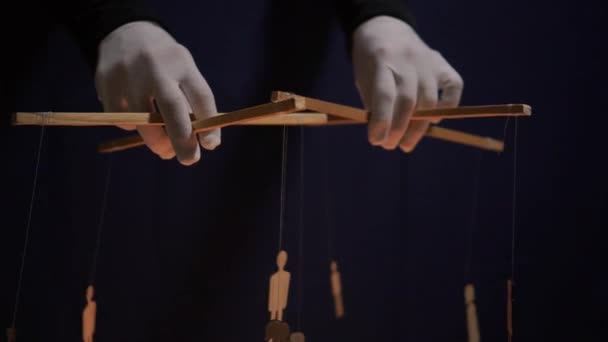Conspiracy theory concept. People - puppet dolls marionette controlled from above using wires or strings in the hands of the puppeteer — Stockvideo