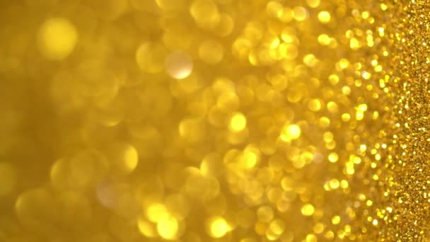 Gold Glitter Background. Light bokeh, magic christmas lights, shiny texture, holiday lights, flying particles form a beautiful bokeh. Shining festive Christmas backdrop. Vertical Video — Stock Video