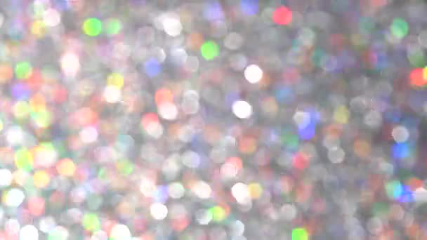 Magiczne uroczyste srebrne tło dla szczęśliwego Nowego Roku. Neon pastel jasne magiczne światła abstrakcyjne tło. Zamazane kolorowe kropki światła. Pył lub cząstki latające — Wideo stockowe