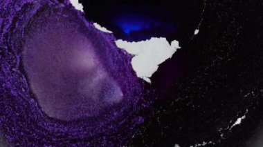 Neon very peri blue purple black colors ink and shiny particles macro. Fluid art. Liquid abstractions. Abstract painting texture. Moving colorful amazing organic background