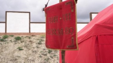 Historical red flag Vexillum or vexilla like object used as a military standard by units in the Ancient Roman army. Roman Legionnaires Camp