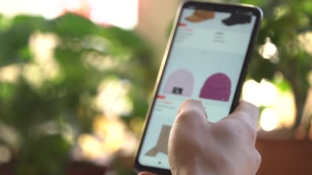 A Man at Home Using Smartphone Buys in Internet Shop. Customer Orders hat In An Online Store Using a Smartphone. Online Shopping — Stock Video