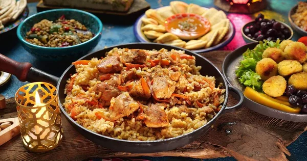 Comida tradicional del Ramadán. Pilaf plov o pilau es un plato de arroz, añadiendo especias y carne. Ajuste de la mesa Eid al-Fitr, comidas halales — Foto de Stock