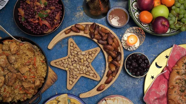 Ramadan kareem with dates, nuts and sweets arranged in shape of islamic crescent moon and star. Iftar food concept, holiday table — Stock Photo, Image