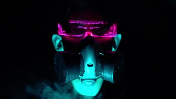 Cyberpunk style. Digital technologies, cybernetics and virtual reality. An Asian young man in a night city among neon lights. Smoke from a respirator — Stock Video