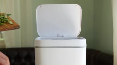 Vegetables scraps in the compost bin. Food waste. Contactless Smart Touch Trash Can. High quality 4k footage