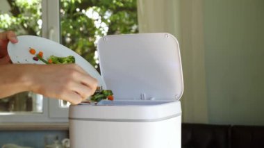 Throwing away uneaten food at home. Household Food Waste. Contactless Smart Touch Trash Can. High quality 4k footage