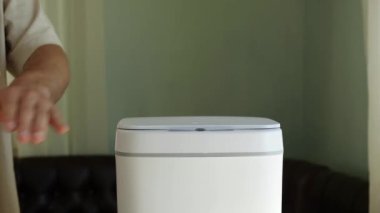 The used medical mask is thrown away. Contactless Smart Touch Trash Can. High quality 4k footage