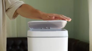 Stale uneaten vegetables are thrown into the trash. Food waste. Contactless Smart Touch Trash Can. High quality 4k footage