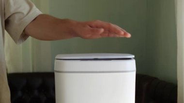 The egg carton made of pulperboard is thrown into the trash. Recycling of paper waste. Contactless Smart Touch Trash Can. High quality 4k footage