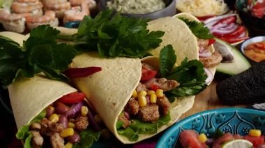 A burrito is a dish in Mexican and Tex-Mex cuisine, consisting of a flour tortilla wrapped into a around various ingredients. High quality 4k footage