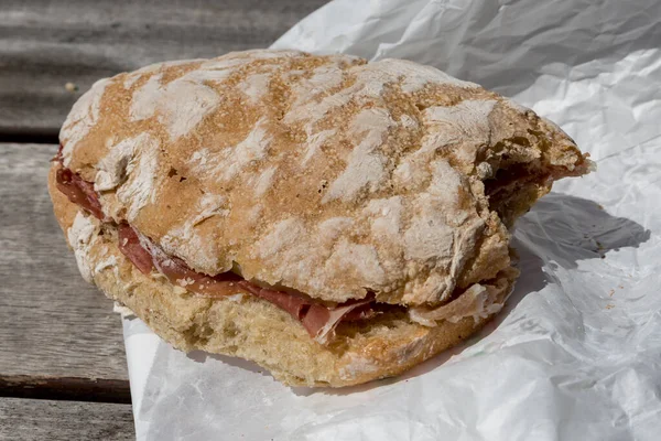 Bitten ham sandwich with rustic bread