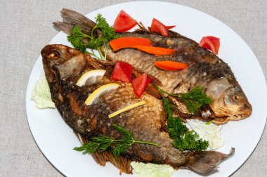 Fresh crucian river fish fried in lemon juice and fresh herbs