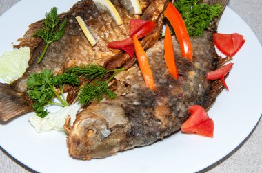 Fresh crucian river fish fried in lemon juice and fresh herbs.