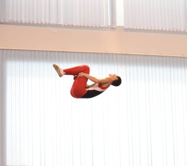 Young men are training in trampoline jumping, preparing for competitions 