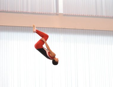 Young men are training in trampoline jumping, preparing for competitions 
