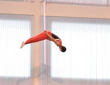Young men are training in trampoline jumping, preparing for competitions 