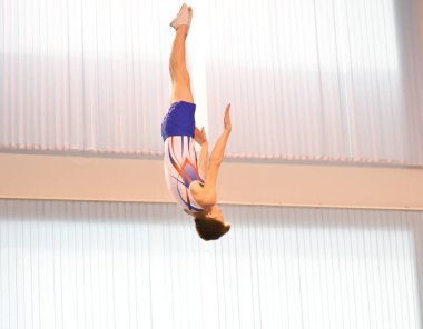 Young men are training in trampoline jumping, preparing for competitions 