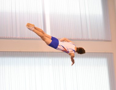 Young men are training in trampoline jumping, preparing for competitions 