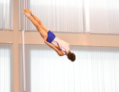 Young men are training in trampoline jumping, preparing for competitions 