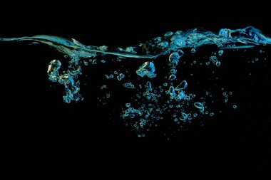 Clear water surface with ripple and bubbles in blue and yellow light on a black nature background