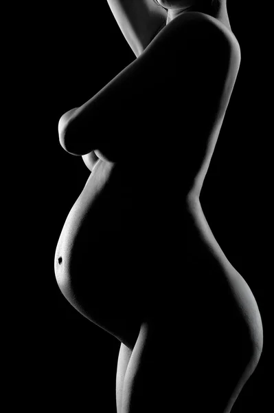 블랙에 8 개월 임신한 여자의 배 스톡 이미지