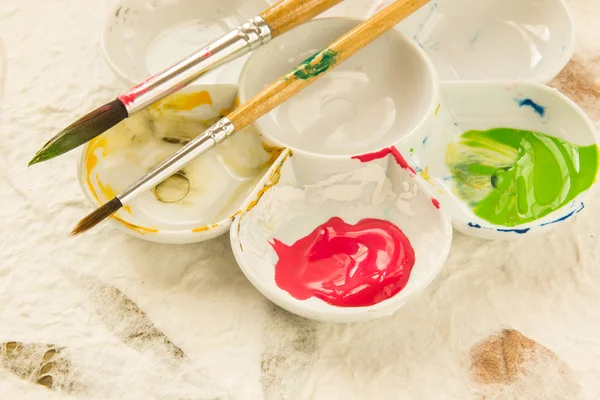 Paintbrush and ink in the palette — Stock Photo, Image