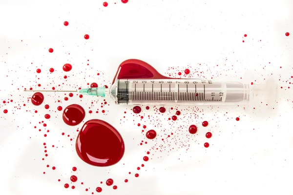 Syringe with blood splash — Stock Photo, Image