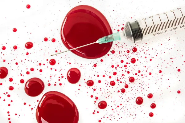 Syringe with blood splash — Stock Photo, Image