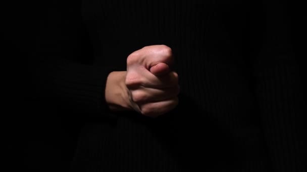 A hand showing fico, fig gesture on black background — 图库视频影像