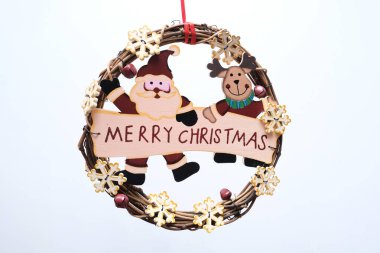 Plain holiday wreath with Merry Christmas sign on white background.