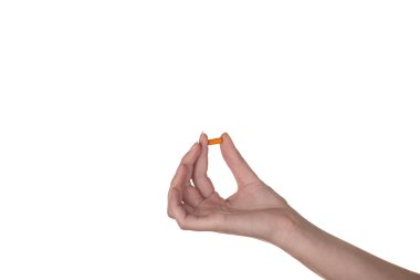 turuncu bir kapsül beyaz zemin üzerine izole tutmak el