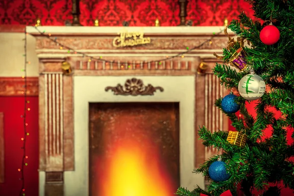 Christmas tree with ornaments on a fireplace background — Stock Photo, Image