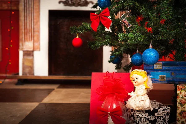 Christmas angel with a fireplace on background — Stock Photo, Image